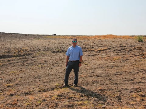 Aaron Fukuda, general manager of Tulare Irrigation District, stands in a basin that's designed to capture floodwater so that it can replenish depleted aquifers.