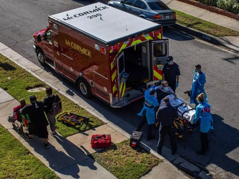 County of Los Angeles paramedics load a potential COVID-19 patient into an ambulance before transporting him to a hospital in Hawthorne, California on December 29, 2020.