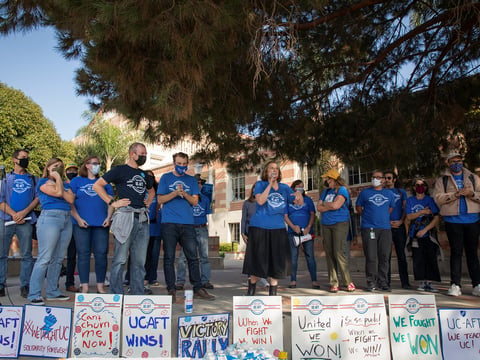 UC-AFT President Mia Mclver, (center) invites UC faculty members to walk on stage to celebrate the cancelation of the UC lecturers strike at UCLA on Nov. 17, 2021.