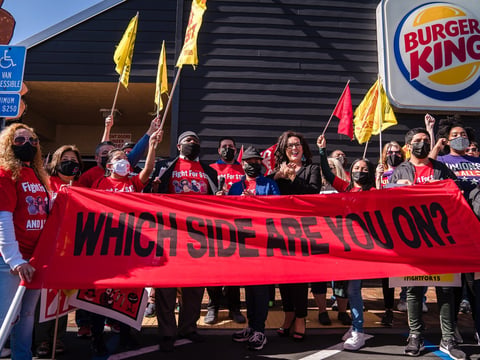 Assemblywoman Lorena Gonzalez, D-San Diego, Yusef Miller with the Racial Justice Coalition and Karina Narinan, a Burger King employee, pose for a photo along with others at a strike for better working conditions and to demand passage of AB 257.