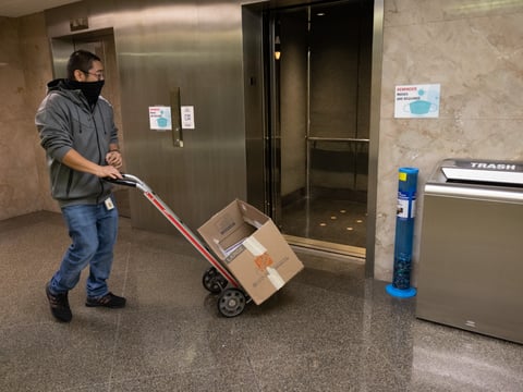 A worker moves a box in the California Capitol, Nov., 22, 2021.