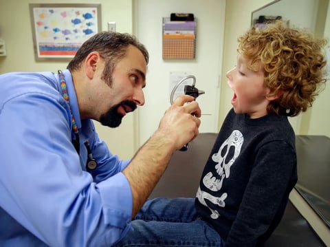 Pediatrician Nelson Branco examines a child-patient during a medical checkup at the Tamalpais Pediatrics clinic in Greenbrae on Feb. 6, 2015.