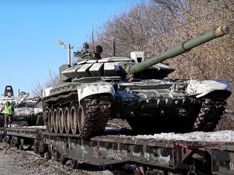 In this photo taken from video provided by the Russian Defense Ministry Press Service on Wednesday, Russian army tanks are loaded onto railway platforms to move back to their permanent base after drills in Russia.