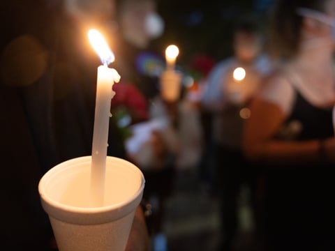 Vigil attendees gather at 7th and K street in Downtown Sacramento on Monday, April 4, 2022.