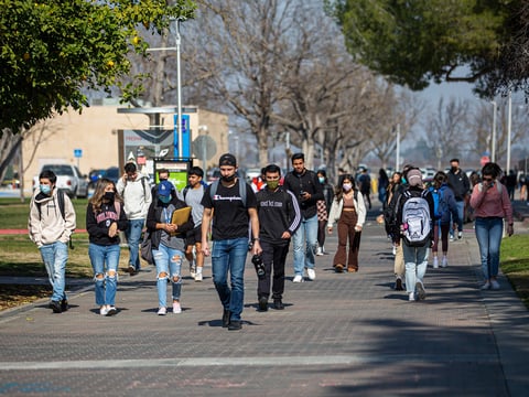 Cal State campuses with have new admissions requirements soon. Here, students walk across campus at Fresno State on Feb. 8, 2022.