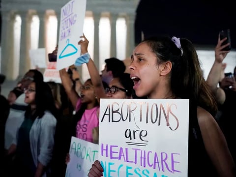 A crowd gathers outside the U.S. Supreme Court in Washington, D.C., early on Tuesday after a draft opinion was leaked indicating the court could strike down Roe v. Wade.