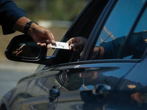 A California Highway Patrol officer stops a motorist who was suspected of speeding along Interstate 405 freeway in Westminster on April 23, 2020.