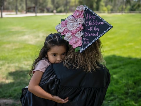 Yessenia Cervantes, 34, holds her youngest daughter, Issabella Cervantes, at California Citrus State Historic Park in Riverside on June 17, 2022.