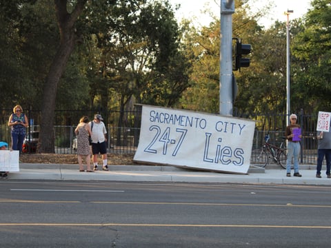 Protesters rally outside a city respite center in northeast Sacramento on Monday, July 25, 2022. The City Council on Tuesday voted to open the homeless services center 24/7.