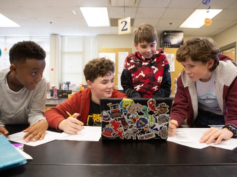 Sixth-graders work together on a science project.