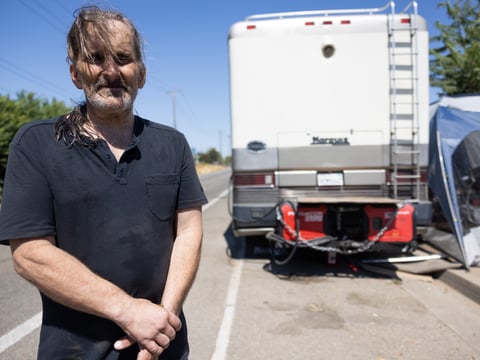 Jon Rocha lives unhoused in Sacramento, and receives water donations to help get through the heat wave, Sept. 6, 2022.