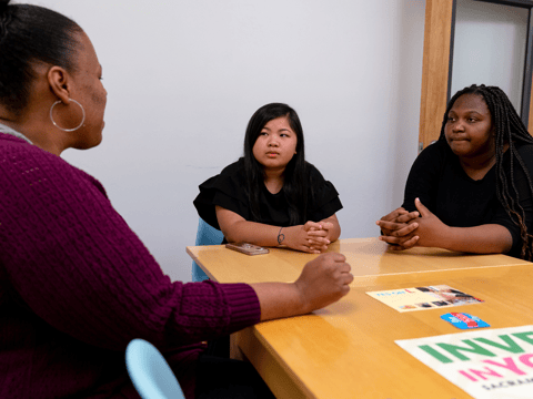 Nakeya Bell with the nonprofit Youth Forward, speaks to two students in her IQ Squad program, Amari Haysbert and Jenalyn Phanh. Bell’s program, IQ Squad focuses on getting women of color increased access to culturally-grounded mental health support.