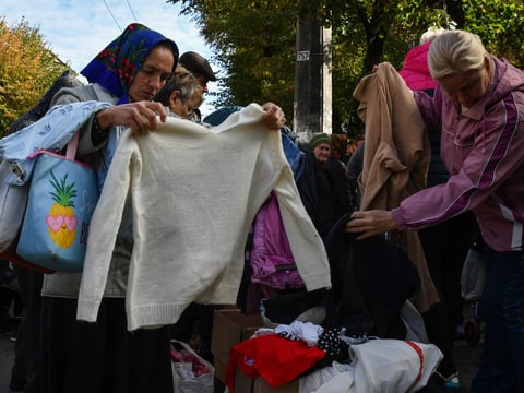 People look through second hand clothes at a humanitarian aid distribution point in Slavyansk, Donetsk region, Ukraine, Thursday, Oct. 6, 2022.