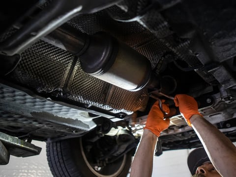 Mechanic Alex Esparza works on a catalytic converter of a vehicle at Van Ness Auto Repair in Fresno on Sept. 13, 2022.