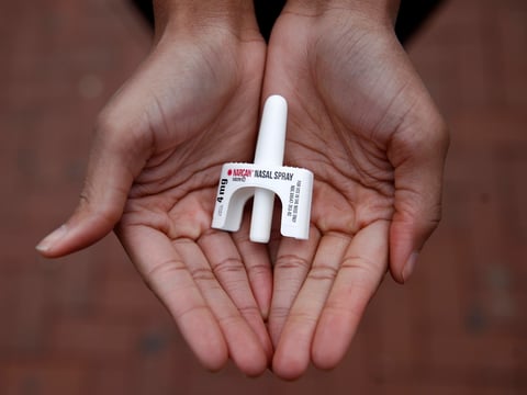 In this Jan. 23, 2018, file photo, Leah Hill, a behavioral health fellow with the Baltimore City Health Department, displays a sample of Narcan nasal spray in Baltimore.