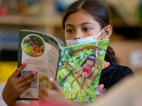Student Layleanah Booker, 9, reads from a book during a reading class at Ethel I. Baker Elementary School in Sacramento in June.