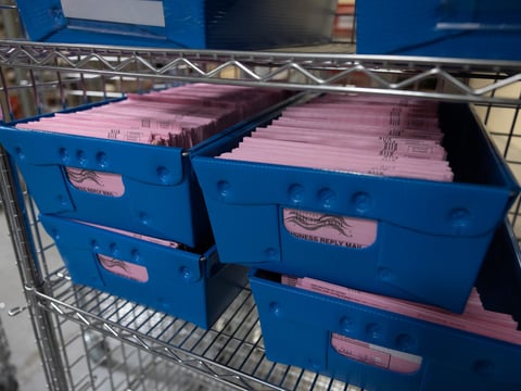Ballots wait to be sorted at the Sacramento County Registrar's Office Tuesday, Nov. 8, 2022.