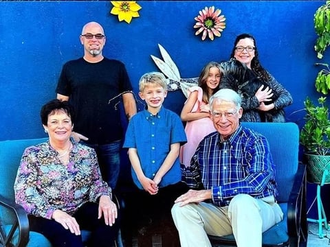 John Williams and his wife, Ann, sit for a picture with his family in Los Angeles during Thanksgiving of 2021.