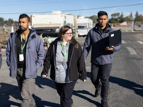Sacramento city homeless outreach workers Jawid Sharifi, Hailey Weaslee and Earl Sapno walk through North Sacramento on Oct. 24, 2022. Teams like theirs, but bolstered with county mental health workers, are part of a new city-county agreement.