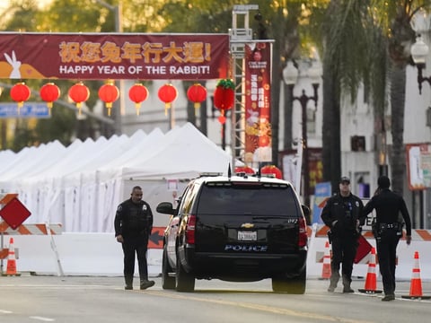A police vehicle is seen near a mass shooting in Monterey Park, Calif., that left 10 people dead at the end of a day of celebration in observance of the Lunar New Year.