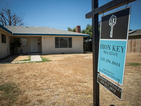 A real estate sign in front of a home in the Tower District in central Fresno on June 28, 2022.