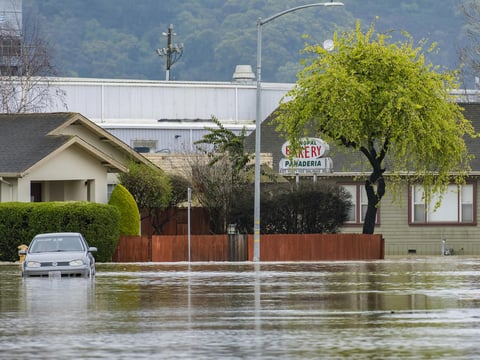A vehicle is stuck in floodwaters in Watsonville, Calif., Saturday, March 11, 2023.
