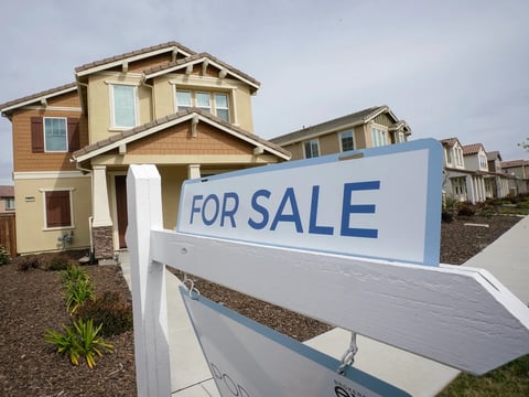 A "for sale" sign is posted in front of a home in Sacramento on March 3, 2022.