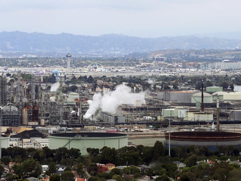 This aerial photo shows the Standard Oil Refinery in El Segundo, Calif., with Los Angeles International Airport in the background and the El Porto neighborhood of Manhattan Beach, Calif., in the foreground, May 25, 2017.