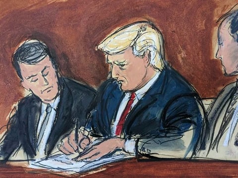 Former President Donald Trump, center, flanked by his defense attorneys, signs his bond in federal court on Tuesday in Miami. Trump plead not guilty to federal charges that he illegally kept classified documents at his Florida estate.