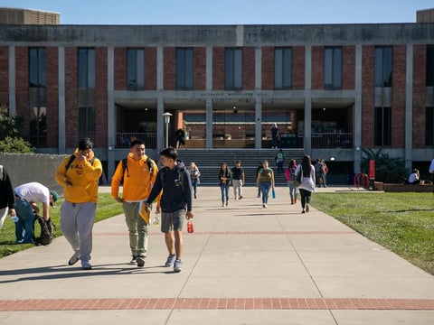 Students walk near Meiklejohn Hall at California State University East Bay on Feb. 25, 2020.