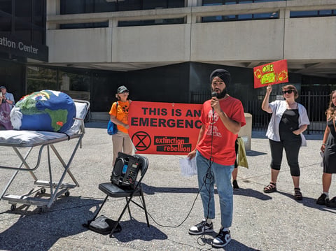 Climate activist Saheb Gulati speaks at a rally outside the Sacramento County Board of Supervisors meeting chambers on July 11, 2023. Activists urged supervisors to reject a recommendation to postpone a carbon neutrality goal.