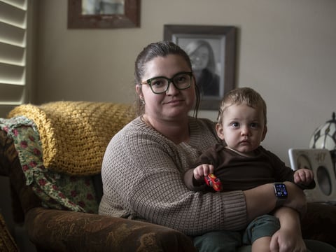 Lainey Arebalo and her son Brady sitting in the living room of her parents home in Templeton on Dec. 19, 2023.