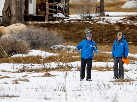 (From left) Sean de Guzman and Anthony Burdock with the state Department of Water Resources walk in the meadow during the first snow survey of the 2024 season at Phillips Station in the Sierra Nevada on Jan. 2, 2024.