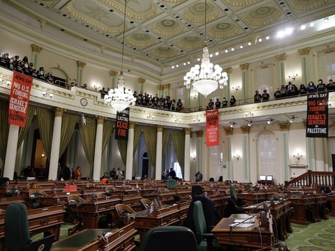 Protesters call for an end to the Israel-Hamas war and interrupt the first day of session in the Assembly chamber on Jan. 3, 2024.