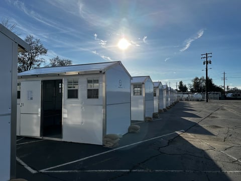 Tiny home shelters are lined up at a new homeless shelter site in north Sacramento on Jan. 5, 2024.