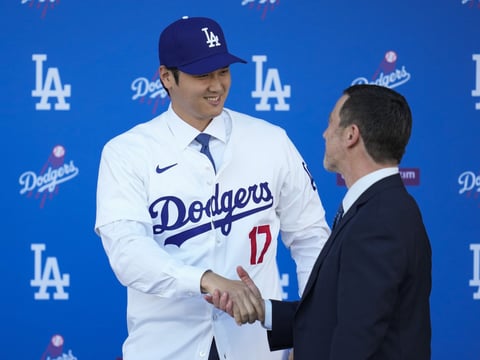 Los Angeles Dodgers' Shohei Ohtani, left, shakes hands with president of baseball operations Andrew Friedman during a baseball news conference at Dodger Stadium Thursday, Dec. 14, 2023, in Los Angeles.