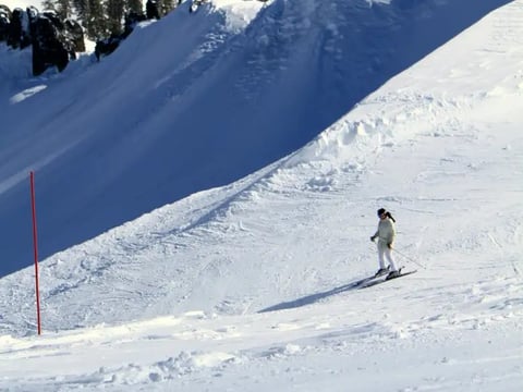 A skier at Palisades Tahoe, home of the 1960 Winter Olympics and site of a small but deadly avalanche in 2024.