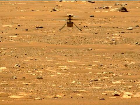 In this image made available by NASA, the Mars Ingenuity helicopter hovers above the surface of the planet during its second flight on April 22, 2021.