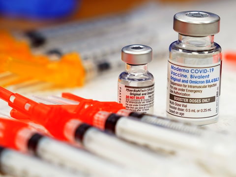 Pfizer, left, and Moderna bivalent COVID-19 vaccines are readied for use at a clinic, Nov. 17, 2022, in Richmond, Va.