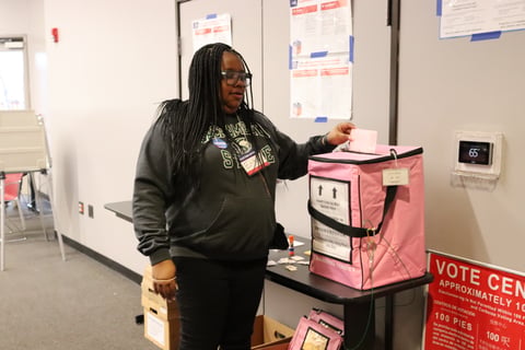 Voting center clerk Erika Nelson Johnson putting her completed ballot into drop box on March 5th, 2024.