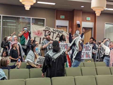 A group of people protesting at the Tuesday, March 19, 2024 Sacramento City Council meeting. Council members were on a recess from hearing public comment on a proposed resolution calling for a cease-fire in Gaza.