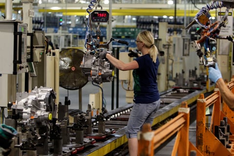 Line worker Cheryl Simpson moves a transmission from the assembly line to a pallet at the Ford Van Dyke Transmission Plant in Sterling Heights, Mich., Thursday, June 9, 2011.
