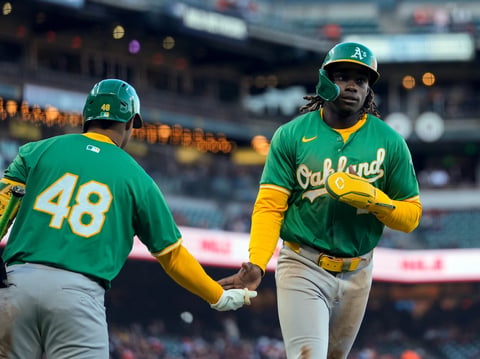 Oakland Athletics' Lawrence Butler, right, celebrates with Darell Hernaiz after scoring San Francisco Giants on Nick Allen's sacrifice fly during the sixth inning of a spring training baseball game Tuesday, March 26, 2024, in San Francisco.