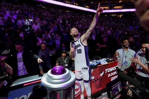Sacramento Kings forward Domantas Sabonis (10) lights the beam after the team's victory over the Golden State Warriors in an NBA basketball play-in tournament game Tuesday, April 16, 2024, in Sacramento, Calif.