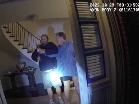 In this image taken from San Francisco Police Department body-camera video, the husband of former U.S. House Speaker Nancy Pelosi, Paul Pelosi, right, fights for control of a hammer with his assailant David DePape during an attack on Oct. 28, 2022.