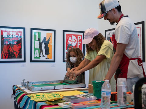 Participants practice screen printing during a demo by TANA at the Latino Center of Art and Culture's Zine Fest on Sunday, May 19.
