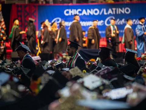 Student graduates walk through the aisles to receive their degrees at the Fresno State Chicano/Latino Commencement Celebration in the Save Mart Center in Fresno on May 18, 2024.