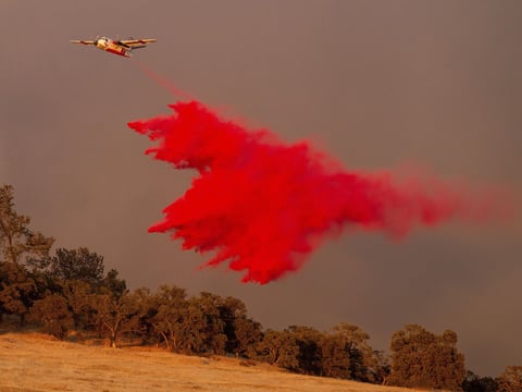 An air tanker drops retardant while battling the Aero Fire in the Copperopolis community of Calaveras County, Calif., Monday, June 17, 2024.