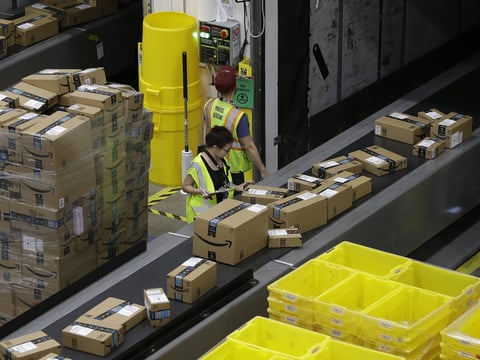 Packages move down a conveyor system were they are directed to the proper shipping area at an Amazon Fulfillment Center in Sacramento, Calif., on Feb. 9, 2018.