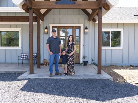 Brian Gobba, left, stands with his wife Morgan and their son in front of the family's new home in Paradise, Calif., Friday, June 14, 2024.